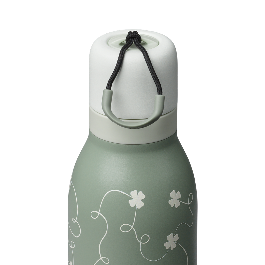 Owala FreeSip Twist 24oz, sage green body with white four-leaf clover pattern, matching sage twist cap and white carry string with sage grip